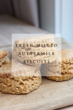 fresh milled buttermilk biscuits on a cutting board with the words, fresh milled buttermilk biscuits