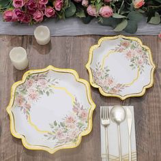 there are two plates with flowers on them and one has a silverware in front of it