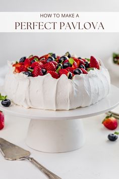 a white cake with berries on top and the words how to make a perfect pavlova