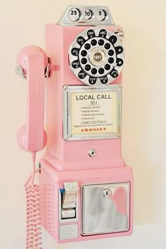 an old fashioned pink rotary phone on display