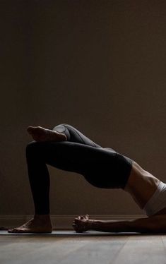 a woman is doing yoga on the floor