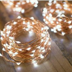 some lights that are on top of a wooden table and one is lit up with string lights