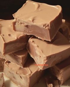 a pile of chocolate fudges sitting on top of a white plate