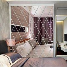 the bedroom is decorated in modern style with mirrored walls and bedding, along with a large mirror wall