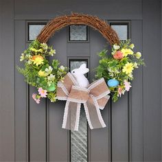 a wreath with an easter bunny on the front door