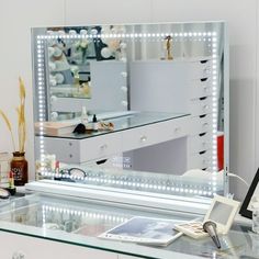 a lighted vanity mirror sitting on top of a table