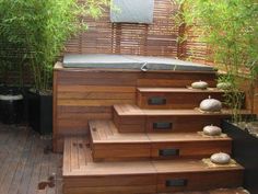 an outdoor hot tub with steps leading up to it