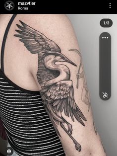 a woman with a bird tattoo on her arm