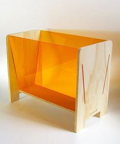 a wooden shelf with an orange glass front