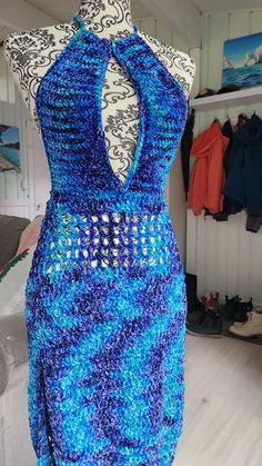 a crocheted dress is displayed on a mannequin