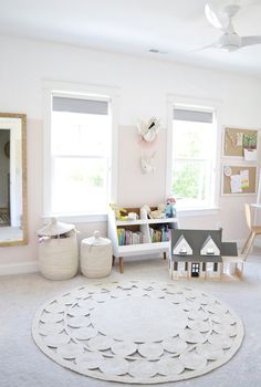 a child's playroom with toys and bookshelves