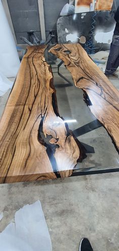 the table is made out of wood and has been polished with black metal legs, which are