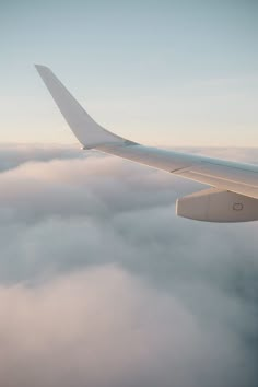 the wing of an airplane flying above the clouds