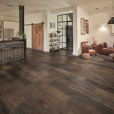 a living room filled with furniture and wooden floors