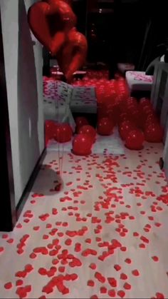 red balloons and streamers fill the floor at a party