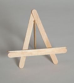 a small wooden easel sitting on top of a table