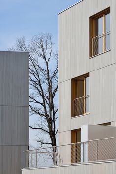 two tall buildings with balconies next to each other