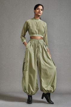 Green three fourth sleeves crop top in textured cotton with ribbed waistline, neckline and sleeve hem. Paired with a baggy-fit cargo pants with strap details on pockets. - Aza Fashions Rust Fabric, High Neck Crop Top, Pant For Women, Balloon Pants, Baggy Cargo Pants, Traditional Indian Outfits, Stylish Women Fashion, Cargo Pants Women, Cargo Pant