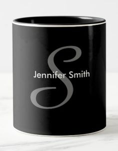 a black and white coffee mug with the letter s on it