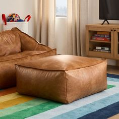 a living room with a large brown leather ottoman