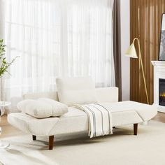 a living room with a white couch and fireplace