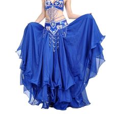 a woman in a blue belly dance outfit with her hands on her hips and one hand on her hip