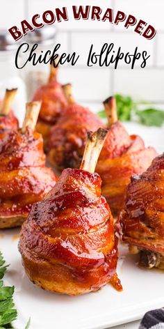 bacon wrapped chicken lollipops on a white platter with garnish