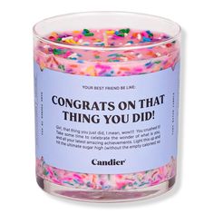 a jar filled with confetti and sprinkles on top of a white surface