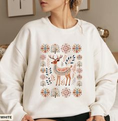 Scandinavian deer sweatshirt gift This custom crewneck sweatshirt brings both incredible quality and amazing style to the mix. Made with soft, ring-spun cotton fabric with 100% cotton threads, it sits unmatched when it comes to softness. All sweatshirts feature a rolled forward shoulder and are printed with OEKO-TEX-certified low-impact dyes. Sustainable cotton sourcing that's good for the environment.  .: 100% ring-spun cotton .: Light fabric (6.4 oz/yd² (217 g/m .: Relaxed fit .: Sewn-in twill White Winter Sweatshirt For Gift, White Winter Sweatshirt Gift, White Embroidered Sweatshirt As Winter Gift, White Winter Sweatshirt As A Gift, White Sweatshirt For Winter Gift, Fall Graphic Print Sweater As A Gift, Fall Graphic Print Sweater Gift, Deer Sweatshirt, Custom Crewneck Sweatshirts