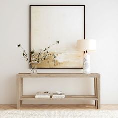 a living room with a large painting on the wall and a wooden table in front of it