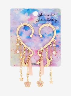 Keep your aesthetic celestial with these gold-tone ear cuffs! They have drop charms of pink faux crystals and hearts  plus gold-tone celestial icons and cherry blossom pendants. Celestial Icons, Aesthetic Celestial, Heart Ear Cuff, Magical Girl Aesthetic, Novelty Jewelry, Cosplay Jewelry, Stacked Earrings, Pink Accessories, Magical Jewelry