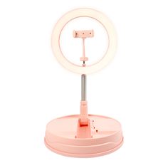 a pink ring light sitting on top of a table