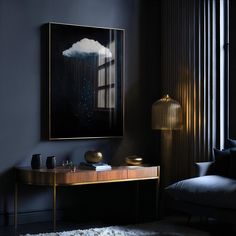 a painting hanging on the wall above a table in a room with a couch and lamp