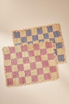 two pieces of woven rugs sitting next to each other