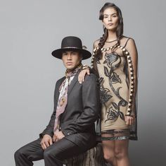 a man and woman posing for a fashion photo