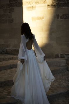 the back of a woman's dress as she walks up some steps