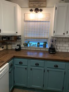 a kitchen with blue cabinets and white appliances