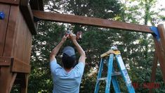 a man is working on a wooden structure