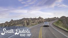 a car driving down the road with mountains in the background and text south dakota road trip