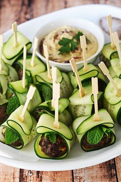 cucumber bites with toothpicks on a plate