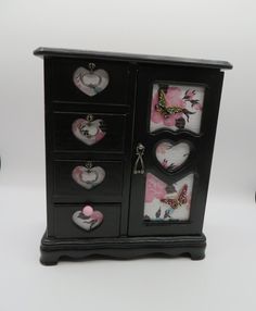 a black cabinet with pink and white hearts on it