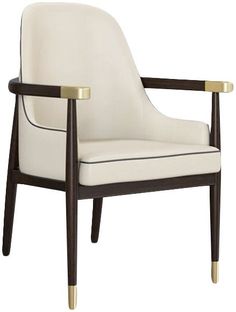 a white chair with gold trim on the armrests and back rests against a white background