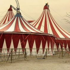 a circus tent with red and white striped tents