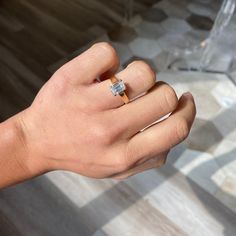 a person's hand with a ring on it