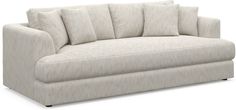 a white couch with four pillows on it's back and two sides facing each other