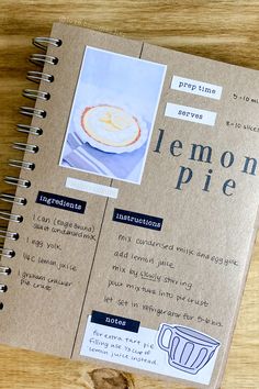 a recipe book on a wooden table with an image of lemon pie in the cover