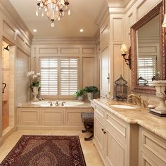 a large bathroom with two sinks and a bathtub next to a rug on the floor