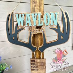 a wooden sign that says waylon real with an antlers head hanging from it