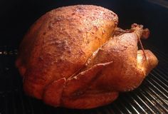 a cooked chicken is sitting on the grill in the oven, ready to be grilled