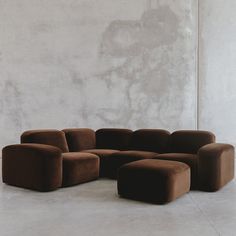 a brown couch sitting on top of a white floor